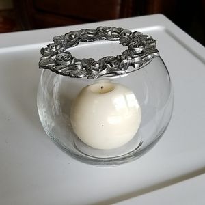 Glass candle holder with a rose silver top